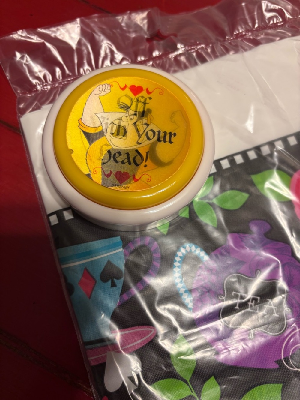 Alice in Wonderland plastic Tablecloth (NWT)and Queen of Hearts push button toy.